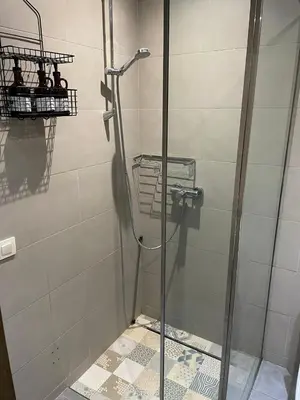 a shower with a glass door in a bathroom at Magnifique Appartement familial avec piscine in Mohammedia