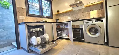 a laundry room with a washer and a washing machine at Green Nest, Loft with private garden-Free Parking- Fast WiFi- Netflix in Casablanca