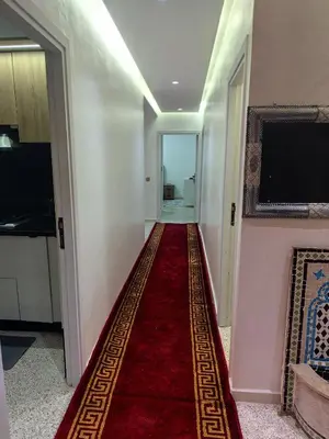 a hallway with a red carpet on the floor at Appartement a Oulad Mtaa ,Prés du stade Moulay Abdallah,Rabat in Rabat