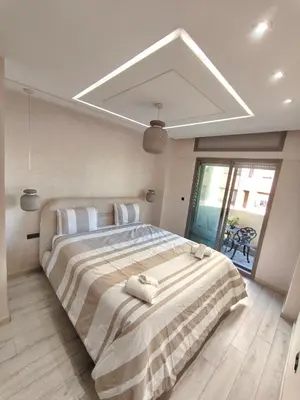 a bedroom with a large bed with two stuffed animals on it at Luxueuse appartement centre ville TGV in Casablanca