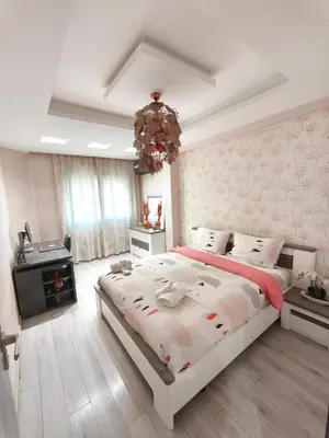 a bedroom with a large bed and a chandelier at Luxueuse appartement centre ville TGV in Casablanca