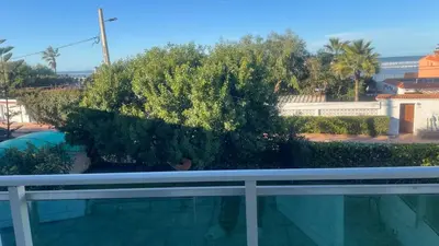 a tree sitting on top of a white fence at Entire villa with sea view - Bouznika Plage David in Bouznika