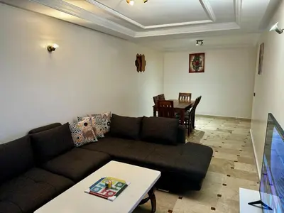 a living room with a couch and a table at Charming Family Appartment in Rabat