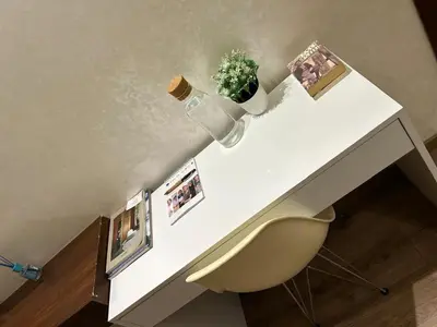 a white desk with a plant and a chair at Studio Calme, Cosy & Équipé, Plein Centre Agdal in Rabat