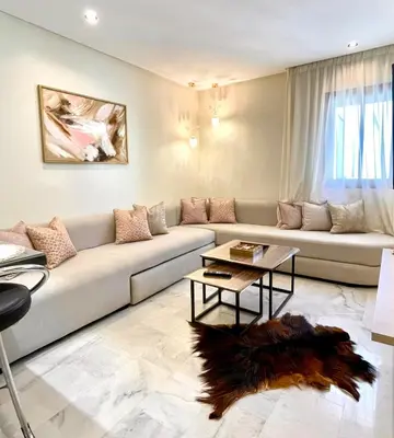 a living room with a couch and a table at Stay Here In Casablanca Center in Oulad Akkou