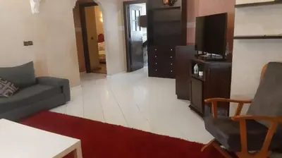 a living room with a couch and a tv at Appartement meublé à Casablanca in Casablanca