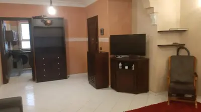 a living room with a flat screen tv and a tv stand at Appartement meublé à Casablanca in Casablanca