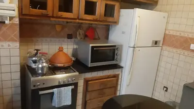 a kitchen with a stove and a microwave and a refrigerator at Appartement meublé à Casablanca in Casablanca
