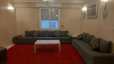 a living room with a couch and a coffee table at Appartement meublé à Casablanca in Casablanca
