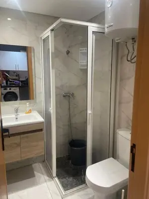 a bathroom with a shower and a toilet and a sink at Résidence Picasso in Casablanca