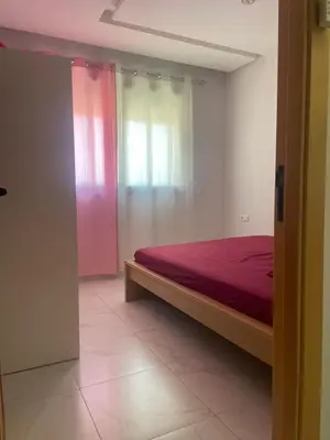 a bedroom with a bed and a window at Résidence Picasso in Casablanca