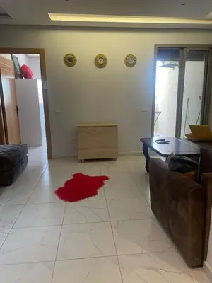 a living room with a red rug on the floor at Résidence Picasso in Casablanca