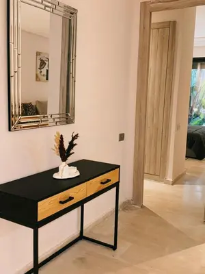 a table in a room with a mirror on the wall at Ain Diab , Luxury El amri in Casablanca