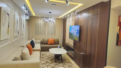 a living room with a couch and a table at Large luxurious apartment opposite to Hassan 2 Mosqu and FAIR international casablanca , near downtown prohibited arb unmarried couples, Free underground parking for buildings, 3 rooms, 2 bathroom, living room in Casablanca