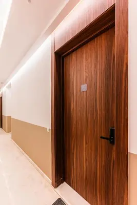 a wooden door in a hallway in a building at New Architect & Design Studio - CFC & Maarif in Casablanca