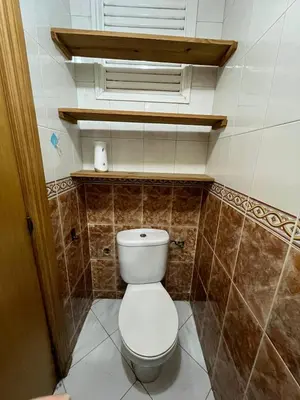 a bathroom with a white toilet in a room at Apartment near the soccer fields in Rabat