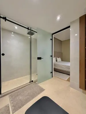 a room with a sliding glass door with a bed at Villa 1 prestige with Pool & Private Guests Suites in Sidi Yahia az Zaʼer
