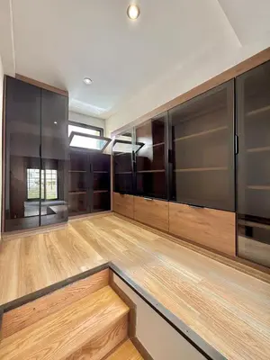 a large room with wooden floors and black cabinets at Villa 1 prestige with Pool & Private Guests Suites in Sidi Yahia az Zaʼer