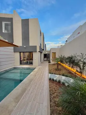 a house with a swimming pool in front of it at Villa 2 Évasion Urbaine, 3 Chambres, à 20 min de Rabat in Sidi Yahia az Zaʼer