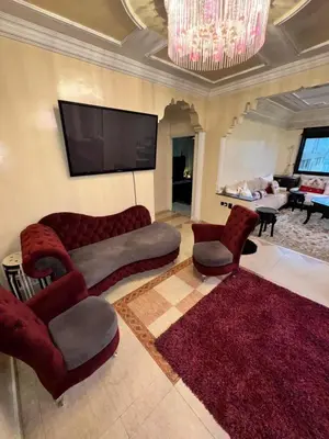 a living room with a couch and chairs and a flat screen tv at Ideal appartement CAN2025 Grand Stade Rabat in Temara