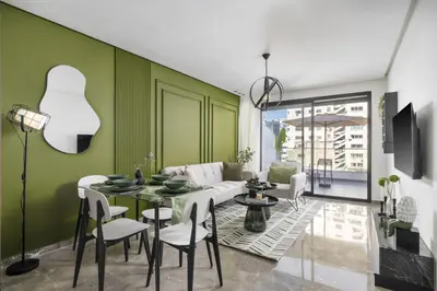 a living room with green walls and a table and chairs at Bright Modern Studio, Gauthier in Casablanca