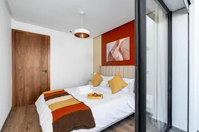 a bedroom with a white bed with yellow pillows at Bright Modern Studio, Gauthier in Casablanca