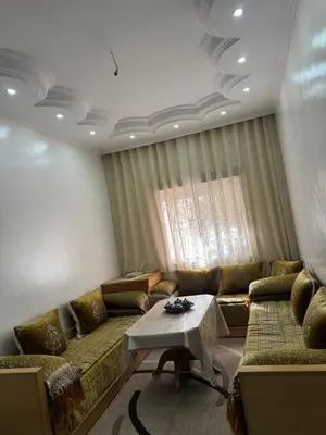 a living room with a couch and a table at Apartment dar bouazza in Dar Bouazza