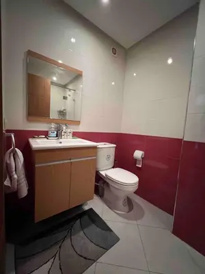 a bathroom with a toilet and a sink and a mirror at Appartment Maarif proche toutes commoditées in Casablanca