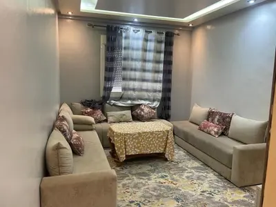 a living room with two couches and a table at Appartement andalous bouskoura in Bouskoura