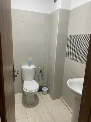 a bathroom with a toilet and a sink at Appartement andalous bouskoura in Bouskoura