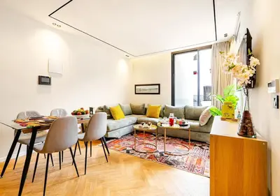 a living room with a couch and a table at Dynasty Estate - Appartement chic et central Yacoub Al Mansour in Casablanca