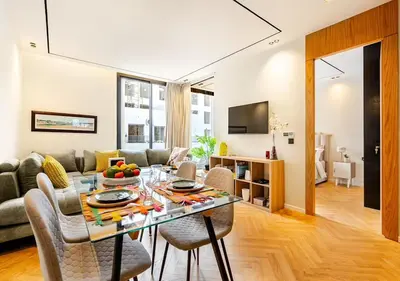 a dining room and living room with a table and chairs at Dynasty Estate - Appartement chic et central Yacoub Al Mansour in Casablanca