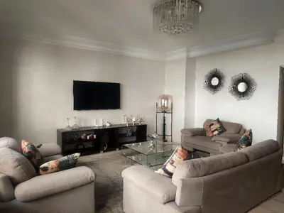 a living room with two couches and a flat screen tv at Appartement Familial Casablanca in Casablanca