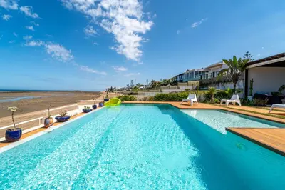 a swimming pool with a view of the ocean at Skhirat Oceanfront Villa 5 Bedrooms Direct Beach Access in Skhirat
