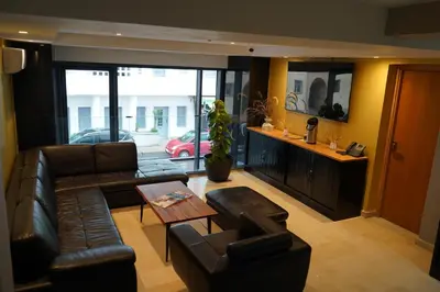 a living room with a leather couch and a table at Agdotel Urban Suites in Rabat