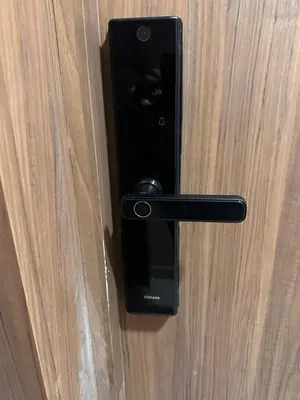 a black door handle on a wooden door at Elegant apartment - Princesses in Casablanca