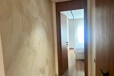 a room with a sliding glass door with a bedroom at Elegant apartment - Princesses in Casablanca