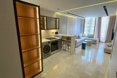 a kitchen and living room with a couch and a stove at Elegant apartment - Princesses in Casablanca