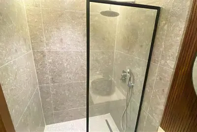a shower with a glass door in a bathroom at Elegant apartment - Princesses in Casablanca