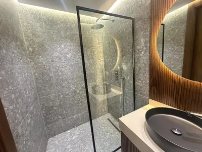 a bathroom with a glass shower and a sink at Luxurious studio for princesses in Casablanca