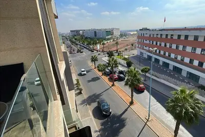 a city street with cars parked in a parking lot at Quiet haven near Sheikh Khalifa Hospital in Casablanca