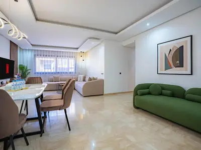a living room with a green couch and a table at Travel and Leisure - By AppartAli in Casablanca