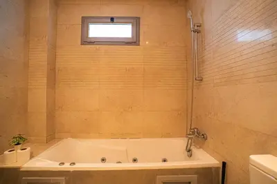 a bath tub in a bathroom with a window at Travel and Leisure - By AppartAli in Casablanca