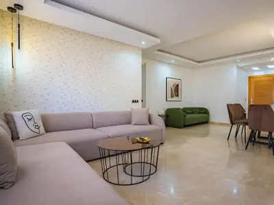 a living room with a couch and a table at Travel and Leisure - By AppartAli in Casablanca