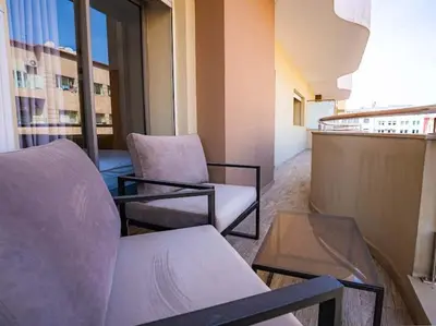 a room with two chairs and a table in a building at Travel and Leisure - By AppartAli in Casablanca