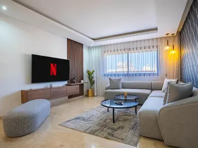 a living room with a couch and a tv at Casa Contemporary 3 Beds - By AppartAli in Casablanca