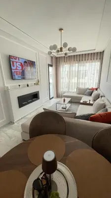 a living room with a couch and a tv at Cozy apartment 2 bedrooms 2 bathrooms in Casablanca