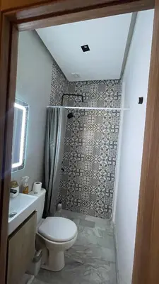 a small bathroom with a toilet and a shower at Cozy apartment 2 bedrooms 2 bathrooms in Casablanca