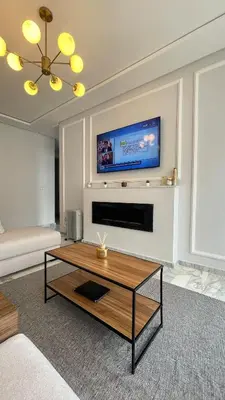 a living room with a coffee table and a tv at Cozy apartment 2 bedrooms 2 bathrooms in Casablanca