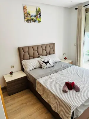 a bedroom with a bed with two slippers on it at Stay luxe in Casablanca